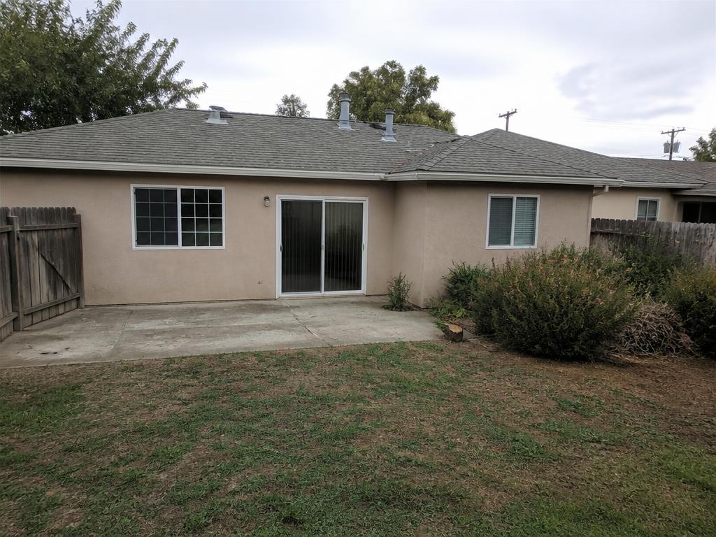 Original dated backyard with worn concrete patio before redesign